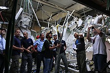 Firefighters and police survey damage at the Hutzot Shopping Center in Ashkelon. (AP)