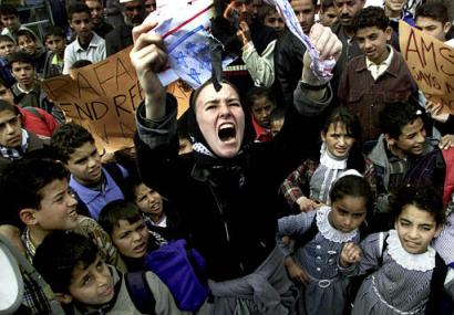 Rachel Corrie at a rally in southern Gaza, burning an American flag