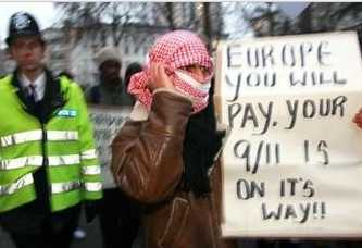 Muslim demonstrator with sign: 'EUROPE YOU WILL PAY.  YOUR 9/11 IS ON ITS WAY!!'