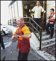 Wounded Israelis leave the scene of today's suicide bombing.