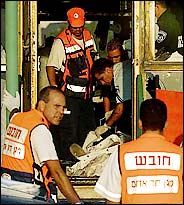 Emergency workers at the scene of the suicide attack in Haifa today.