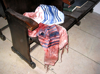 A bloody <i>tallit</i> (prayer shawl) lies on a seat in Istanbul�s Beit Israel synagogue, shortly after the terrorist bombing.